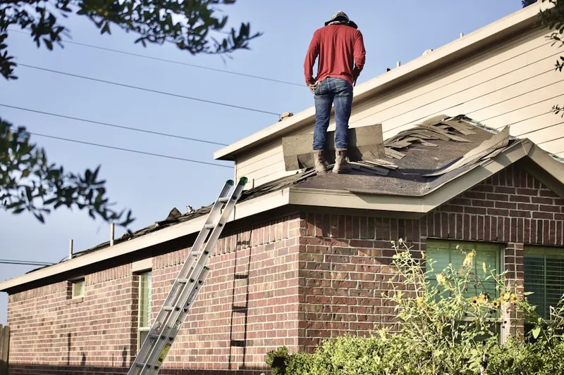 Professional roofer working on a residential roof in River Hills